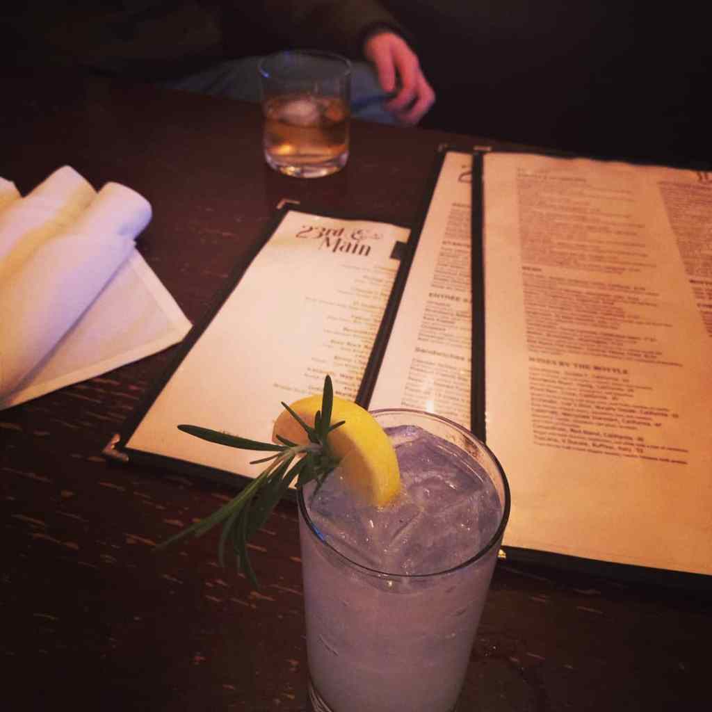 a hip dark restaurant in Richmond Virginia with a cocktail and a menu.