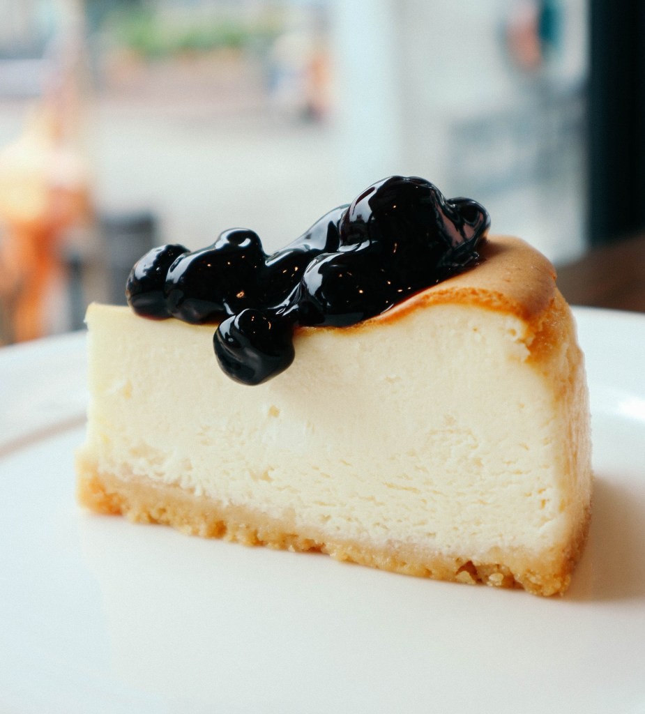 A delicious slice of cheesecake with fruit topping served at a fine restaurant. 